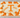 Orange and ivory sheet cake with a large letter T logo hand-piped in buttercream and a congratulations message.