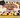 University of Maryland graduation sheet cake with red, yellow, black and ivory piping, a graduation cap and diploma.
